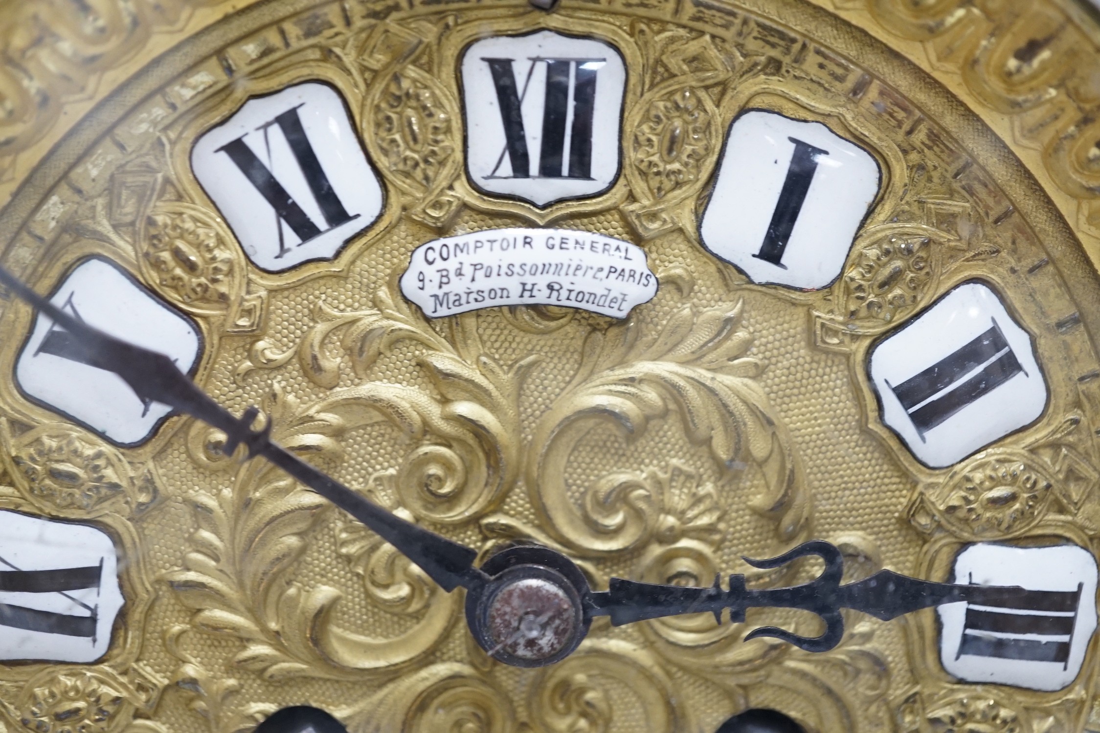 A French brass clock garniture, Comptoir General, 9 Bd Poissenniere, Paris, Maison H. Riondet on an enamel plaque to the dial. Height 42cm